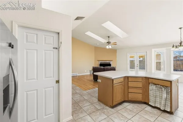 a kitchen with cabinets and window