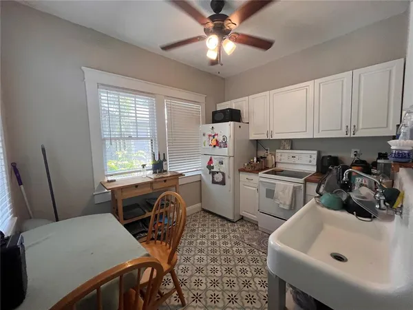 a kitchen with a sink cabinets and window