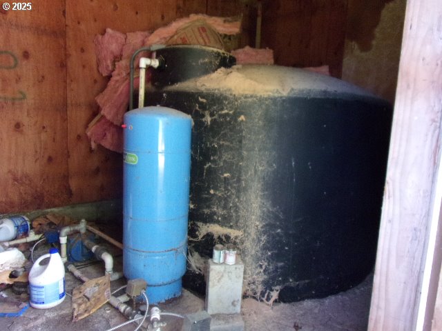 713 Little River Road Glide, OR 97443 - Photo 31 of 36 a room with water heater and wooden cabinets