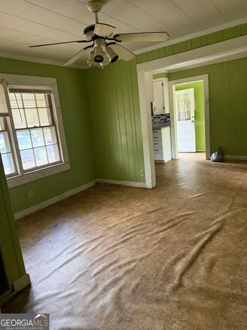an empty room with windows and closet