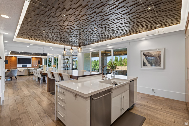 12308 Mariah Circle Draper, UT 84020 - Photo 30 of 293 Open-concept kitchen and living area featuring a decorative wood-panel ceiling with integrated lighting