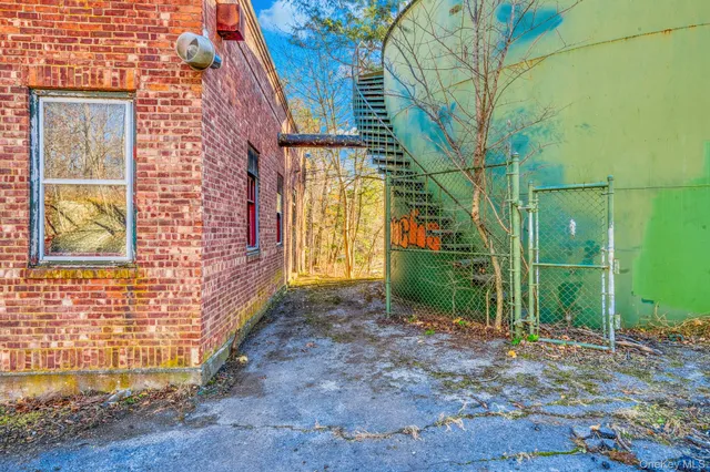 a view of a brick house that has a large windows