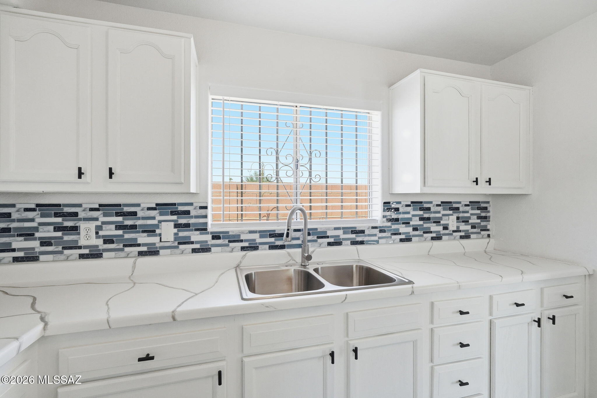 136 West Elvira Road Tucson, AZ 85756 - Photo 15 of 27 a kitchen with granite countertop white cabinets and white appliances
