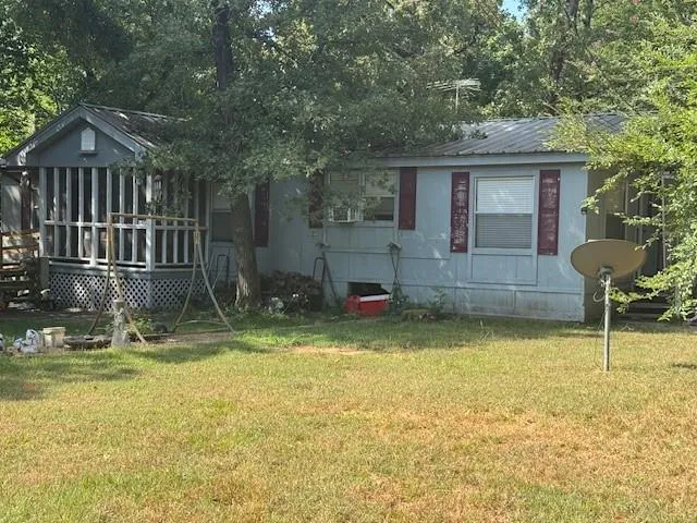 a backyard of a house with barbeque oven