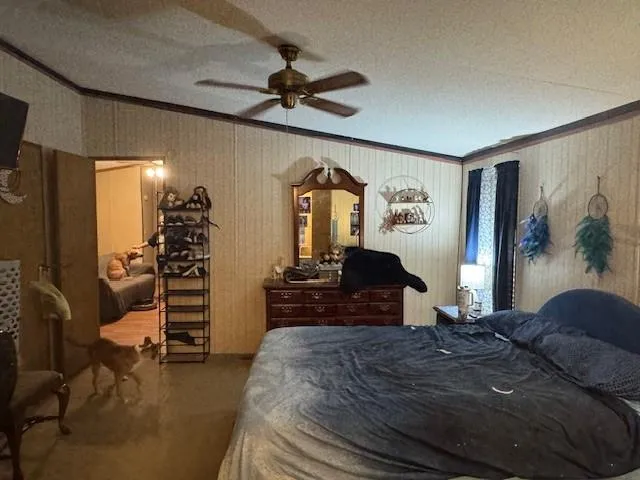 a large bedroom with a bed dresser and a flat tv screen