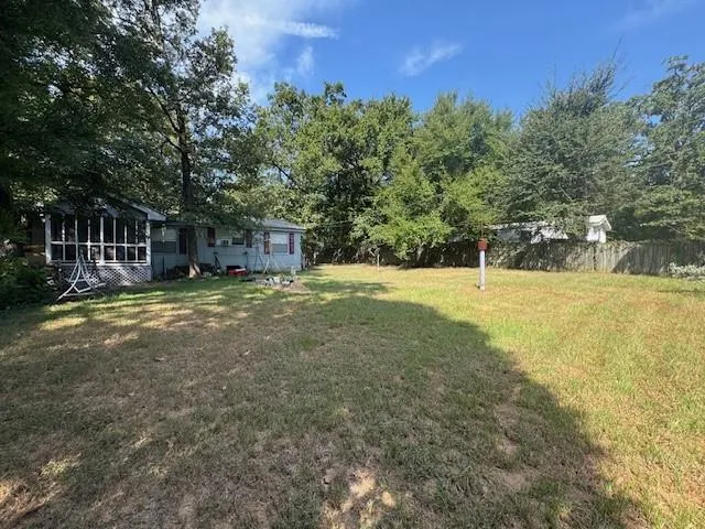 a view of a house with a yard and sitting area