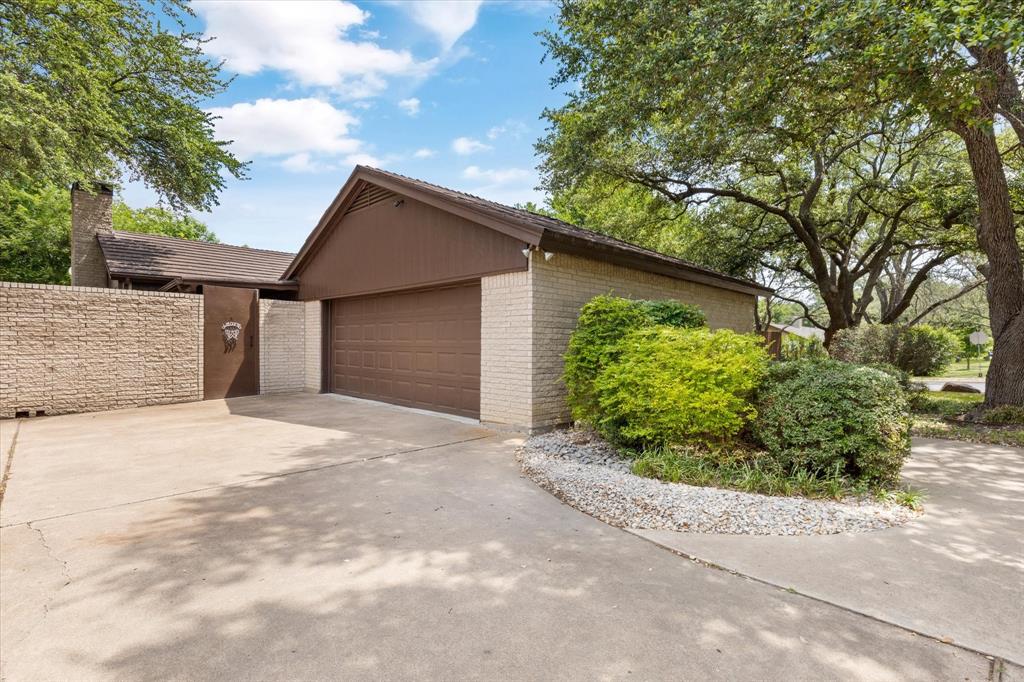 a backyard of a house with a garden and plants