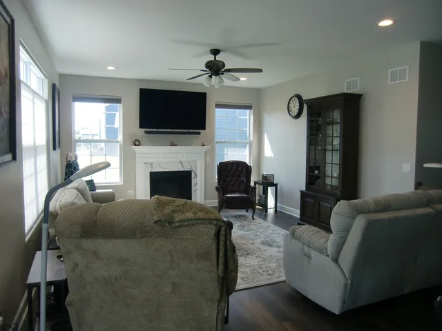 a living room with furniture fireplace and flat screen tv