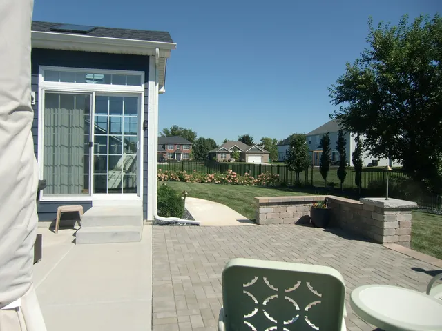 a front view of a house with a garden and trees