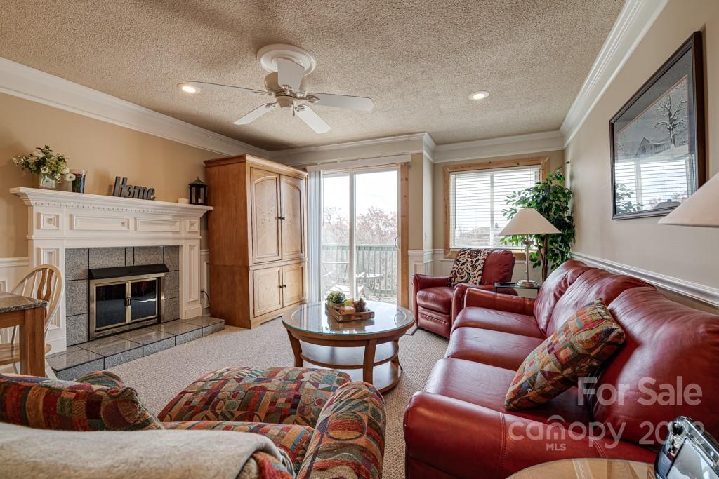 301 Pinnacle Inn Road, Unit 1315 Beech Mountain, NC 28604 - Photo 3 of 47 a living room with furniture a chandelier and a fireplace