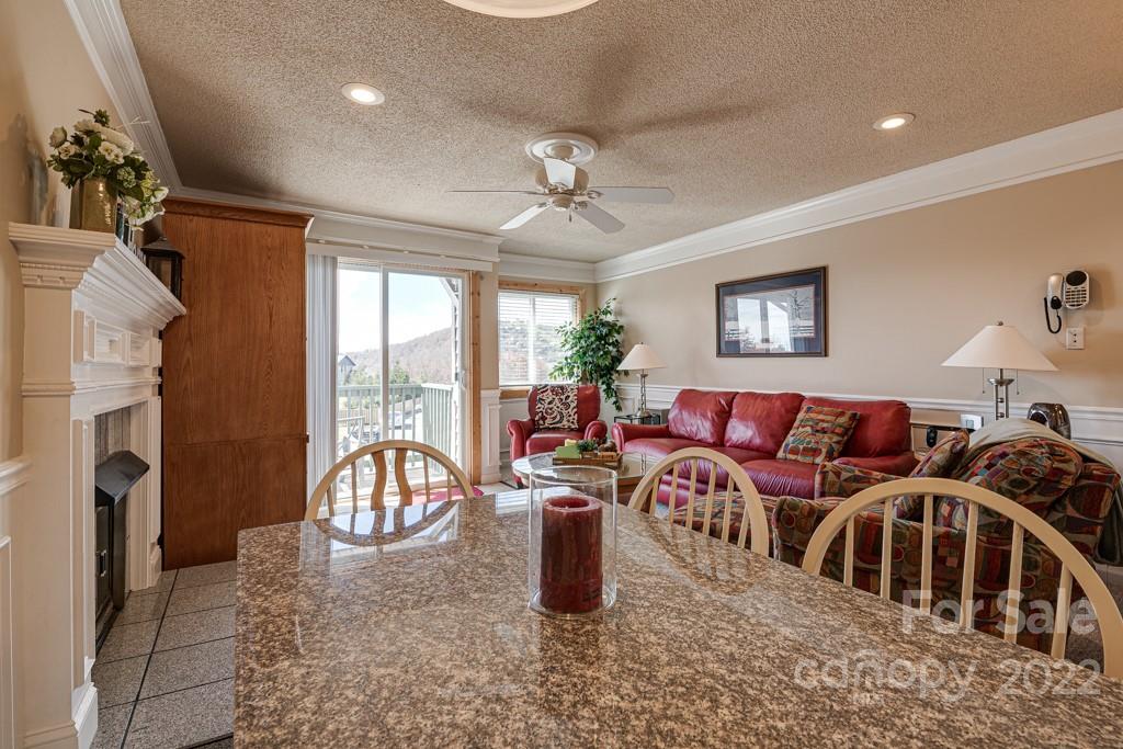 301 Pinnacle Inn Road, Unit 1315 Beech Mountain, NC 28604 - Photo 6 of 47 a living room with furniture a fireplace and a chandelier