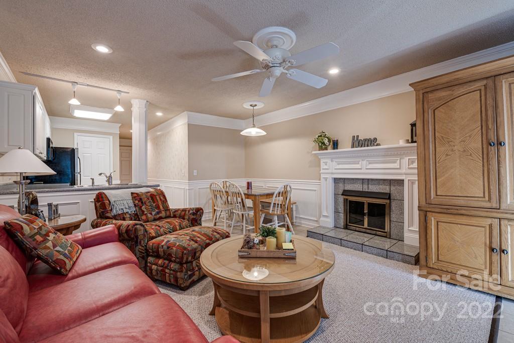 301 Pinnacle Inn Road, Unit 1315 Beech Mountain, NC 28604 - Photo 10 of 47 a living room with furniture a fireplace and a chandelier
