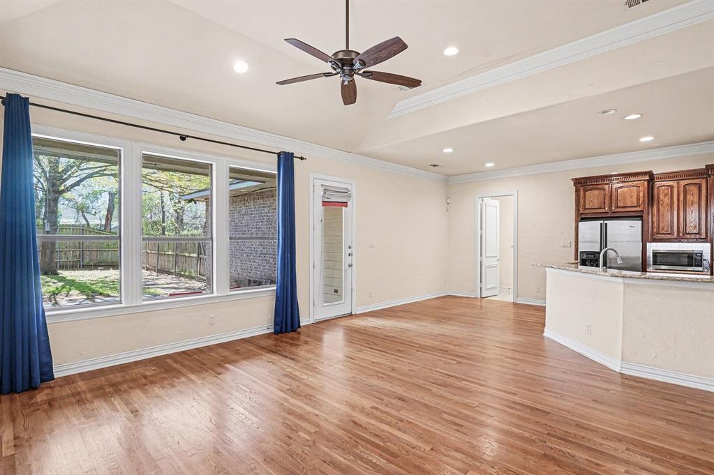5508 Junius Street Dallas, TX 75214 - Photo 11 of 34 a view of an empty room with a window and wooden floor