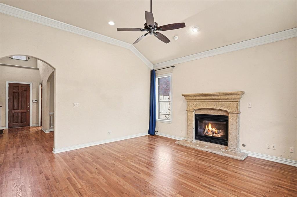 5508 Junius Street Dallas, TX 75214 - Photo 13 of 34 a view of an empty room with wooden floor fireplace and a window