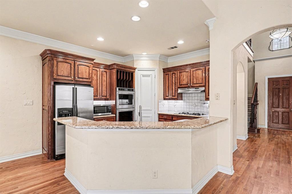 5508 Junius Street Dallas, TX 75214 - Photo 14 of 34 a view of kitchen island a sink wooden floor and living room view