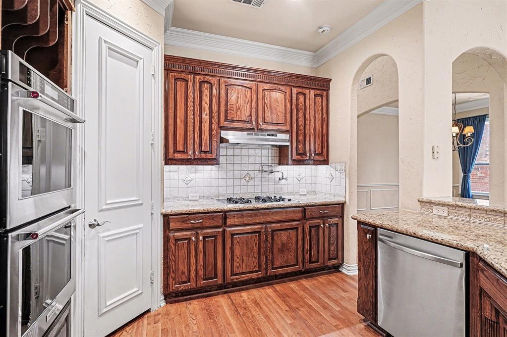 5508 Junius Street Dallas, TX 75214 - Photo 15 of 34 a kitchen with stainless steel appliances granite countertop a stove and a sink