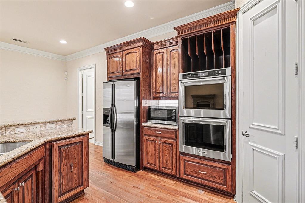 5508 Junius Street Dallas, TX 75214 - Photo 16 of 34 a kitchen with stainless steel appliances granite countertop a refrigerator stove and oven