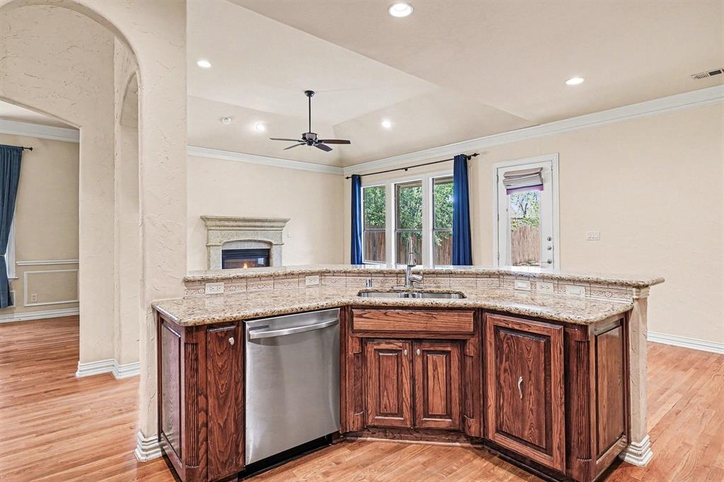 5508 Junius Street Dallas, TX 75214 - Photo 17 of 34 a kitchen with granite countertop cabinets stove and refrigerator