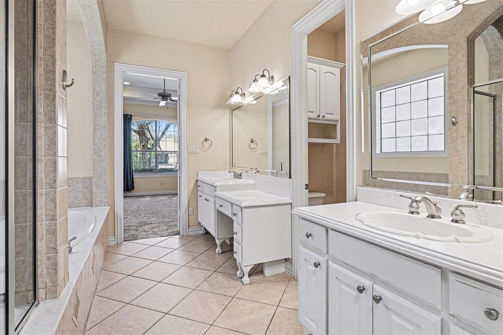 5508 Junius Street Dallas, TX 75214 - Photo 23 of 34 a bathroom with a sink vanity and a mirror
