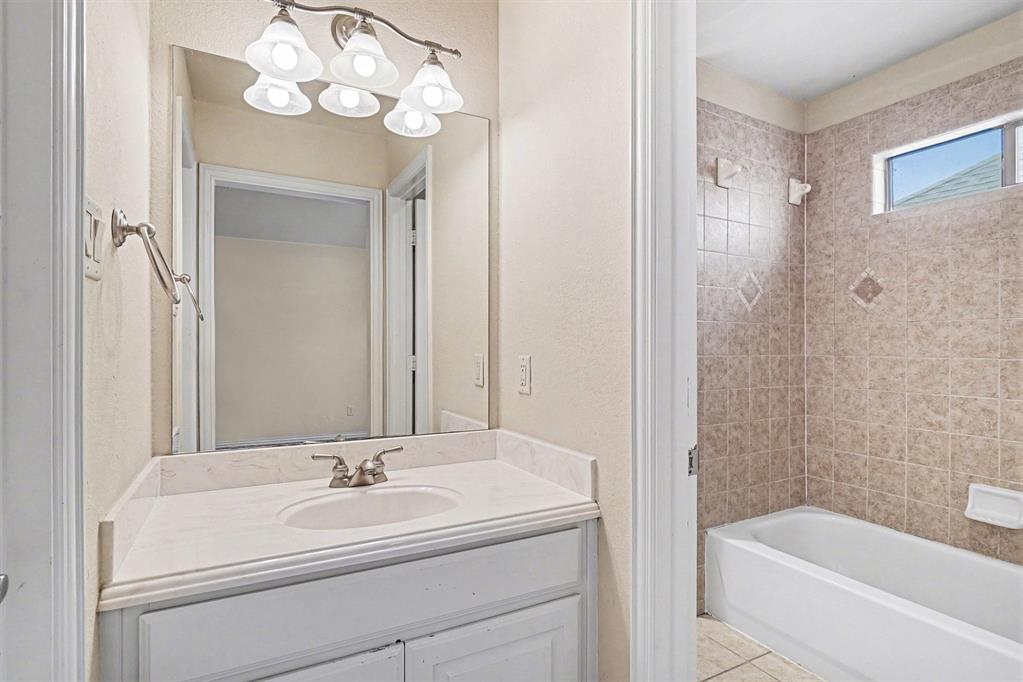 5508 Junius Street Dallas, TX 75214 - Photo 27 of 34 a bathroom with a sink a toilet and shower