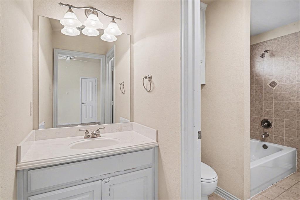 5508 Junius Street Dallas, TX 75214 - Photo 30 of 34 a bathroom with a sink a toilet and shower