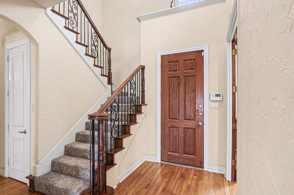 5508 Junius Street Dallas, TX 75214 - Photo 5 of 34 a view of front door with wooden floor and stairs
