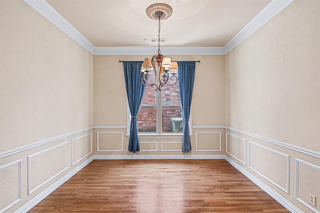 5508 Junius Street Dallas, TX 75214 - Photo 6 of 34 a view of an empty room with wooden floor and a window