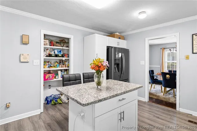 a view of living room with granite countertop furniture and wooden floor