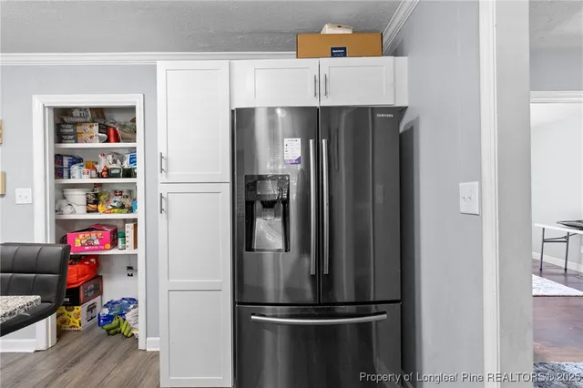 a metallic refrigerator freezer sitting in a kitchen