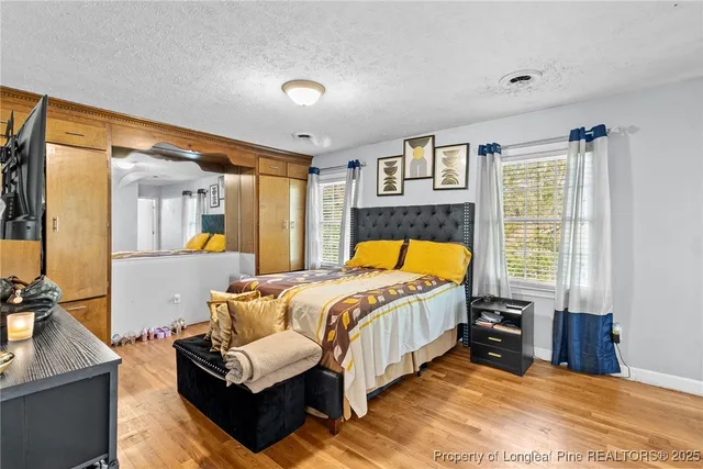 a bedroom with a bed and window