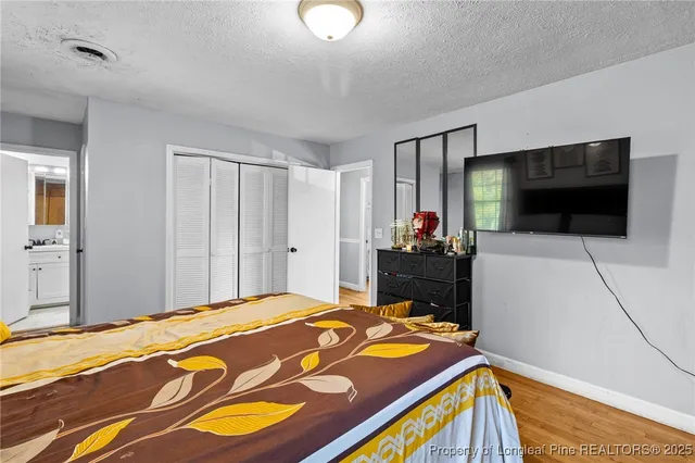 a bedroom with a bed and a flat screen tv