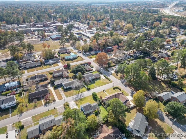 an aerial view of residential building with green space
