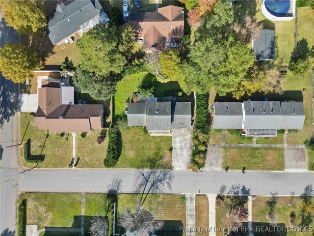 an aerial view of residential houses with outdoor space