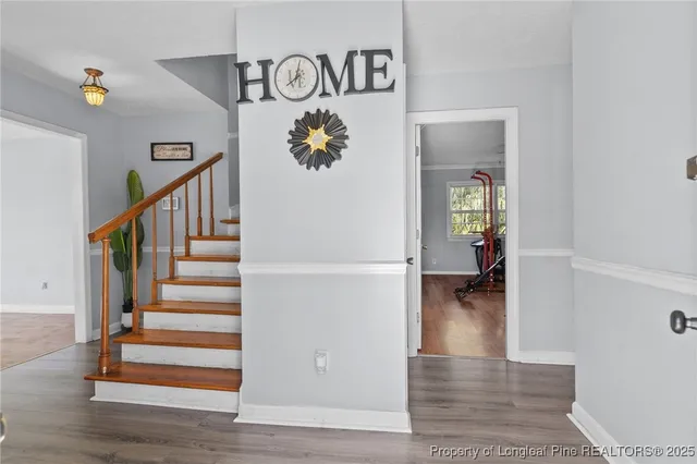 a view of entryway and hall with wooden floor