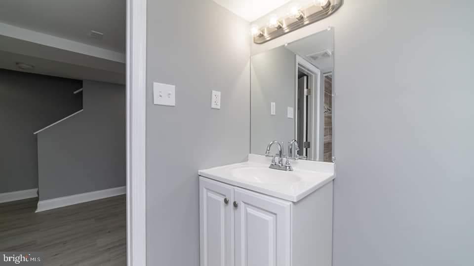 310 Marydell Road Baltimore, MD 21229 - Photo 19 of 26 a bathroom with a sink and a mirror