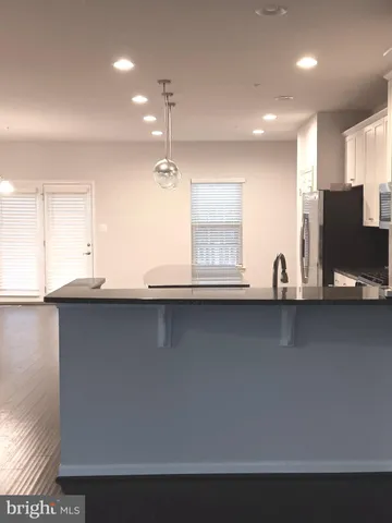a kitchen with stainless steel appliances a sink a stove and a refrigerator