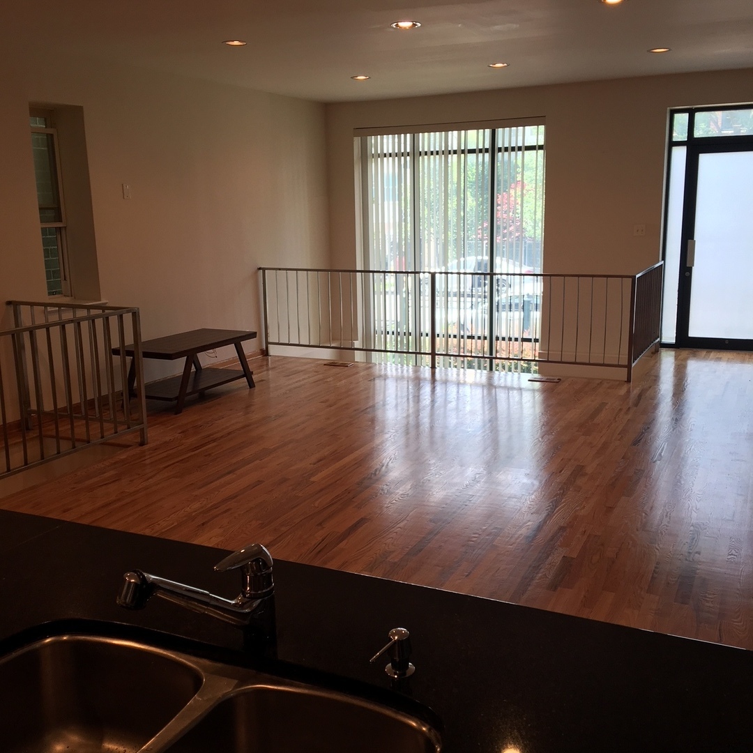 1915 West Huron Street, Unit 2 Chicago, IL 60622 - Photo 11 of 23 a view of empty room with wooden floor and fan