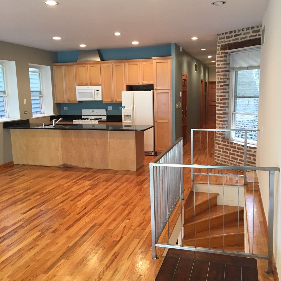 1915 West Huron Street, Unit 2 Chicago, IL 60622 - Photo 13 of 23 a kitchen with stainless steel appliances wooden cabinets a stove and a refrigerator