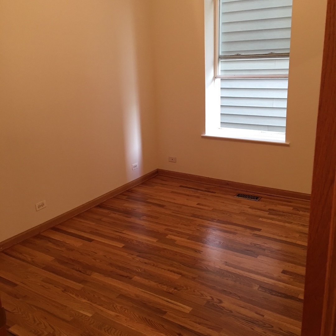 1915 West Huron Street, Unit 2 Chicago, IL 60622 - Photo 14 of 23 a view of an empty room with wooden floor and a window