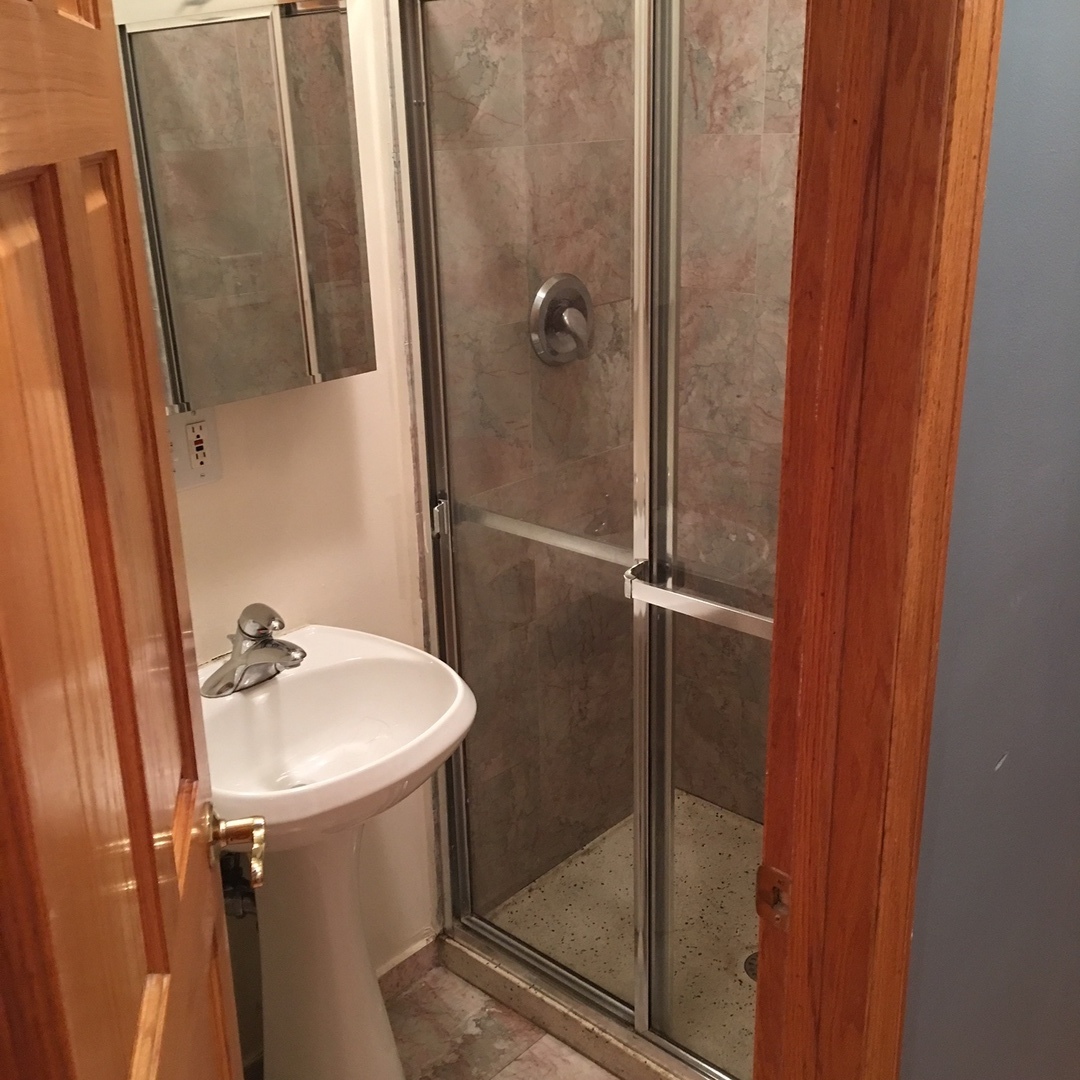 1915 West Huron Street, Unit 2 Chicago, IL 60622 - Photo 15 of 23 a bathroom with a sink a mirror and shower