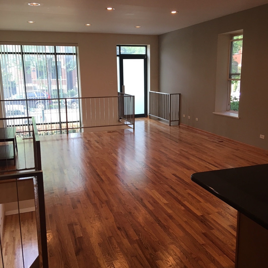 1915 West Huron Street, Unit 2 Chicago, IL 60622 - Photo 10 of 23 a view of empty room with wooden floor and fan
