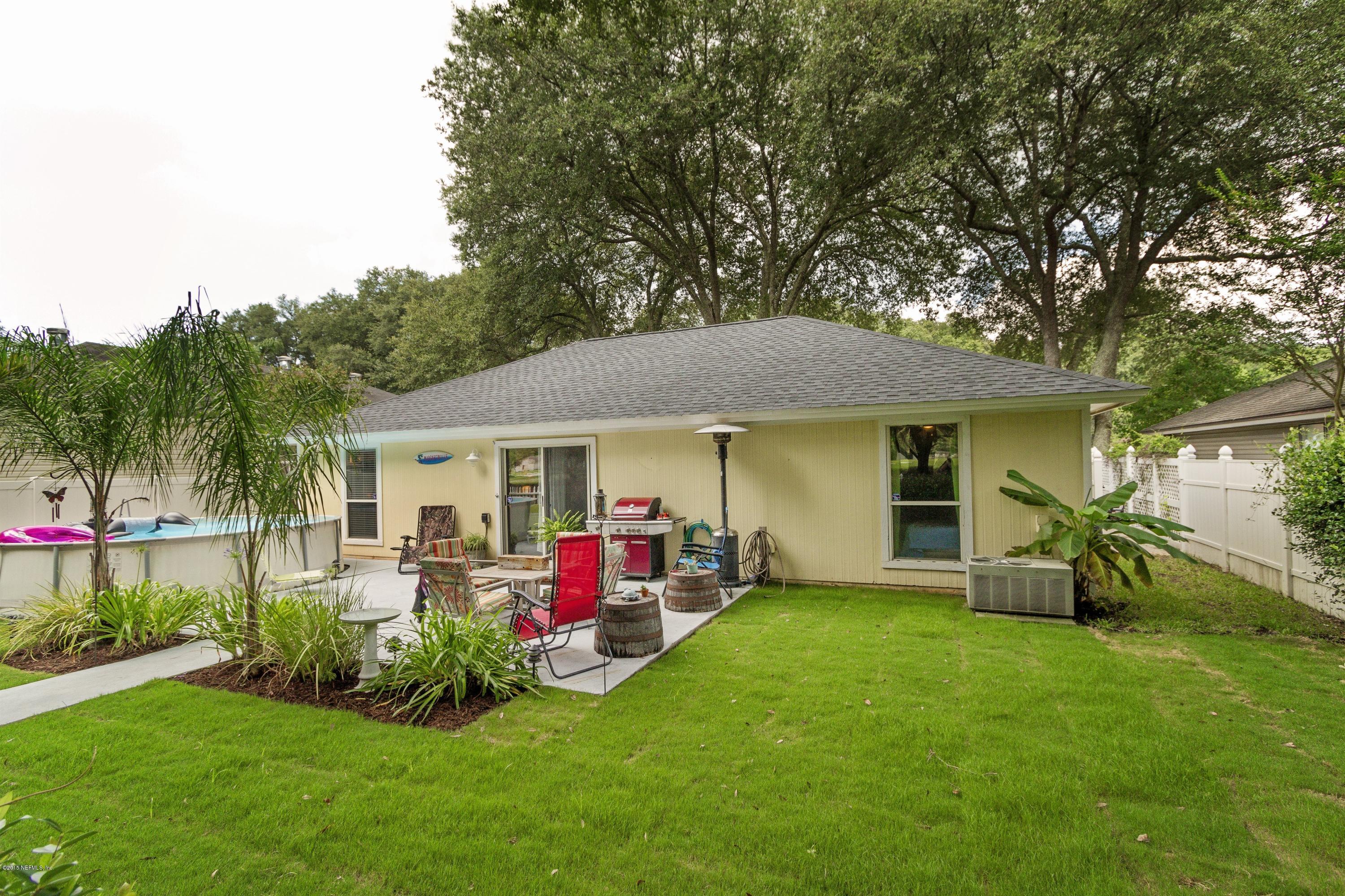 12745 Moose Road Jacksonville, FL 32226 - Photo 23 of 26 a view of a house with a backyard and a patio