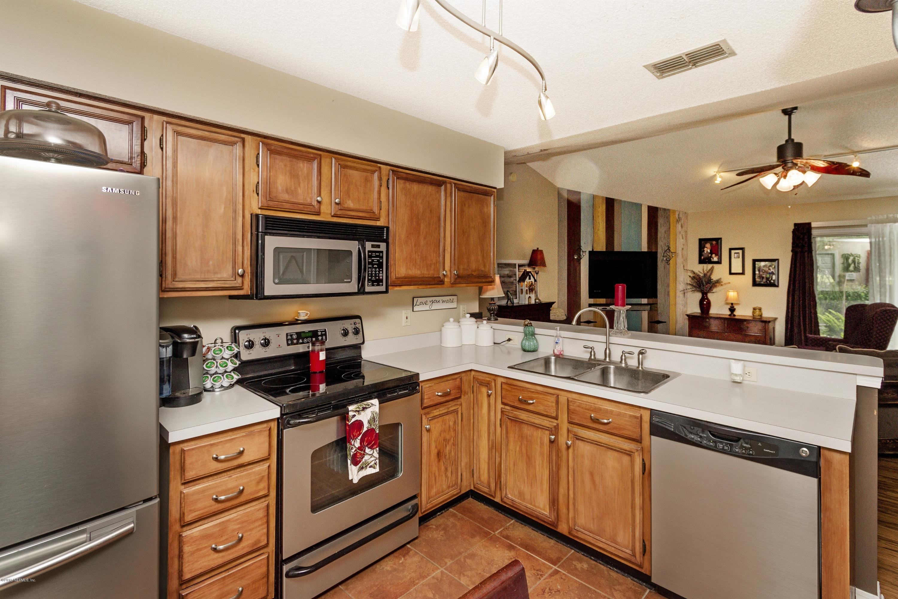 12745 Moose Road Jacksonville, FL 32226 - Photo 5 of 26 a kitchen with a sink stove and microwave