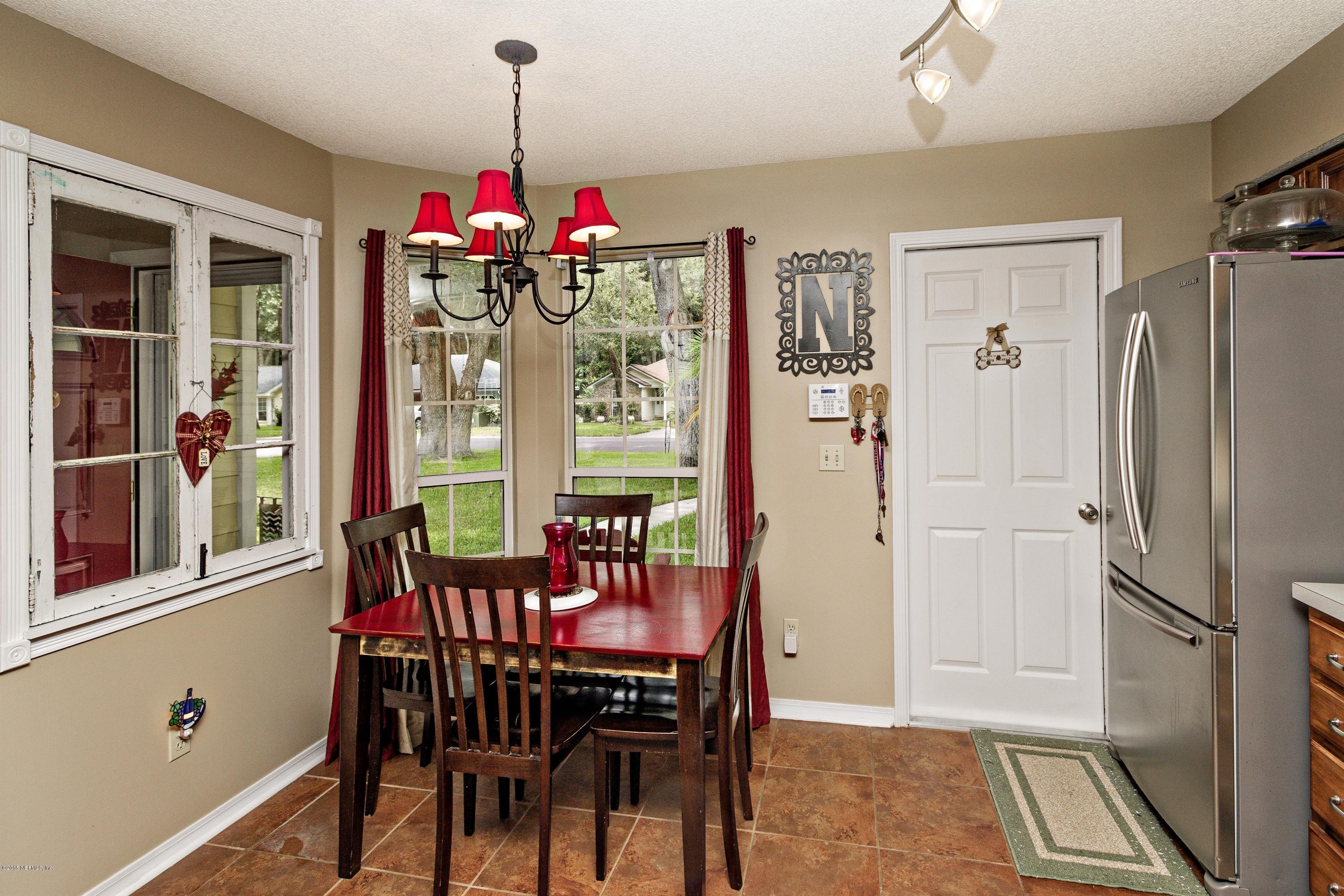 12745 Moose Road Jacksonville, FL 32226 - Photo 8 of 26 a view of a dining room with furniture window and wooden floor