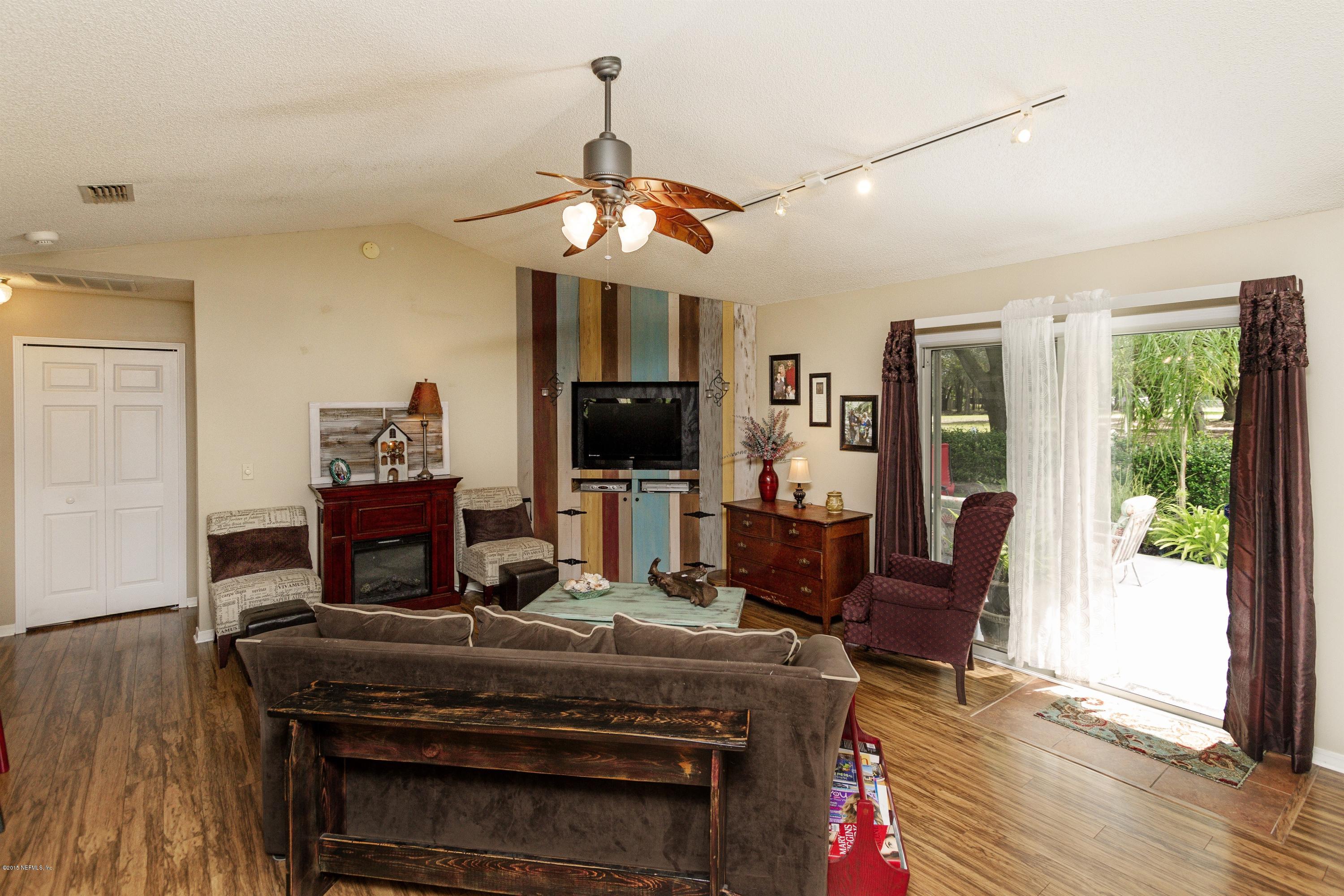 12745 Moose Road Jacksonville, FL 32226 - Photo 9 of 26 a living room with a piano table and chairs