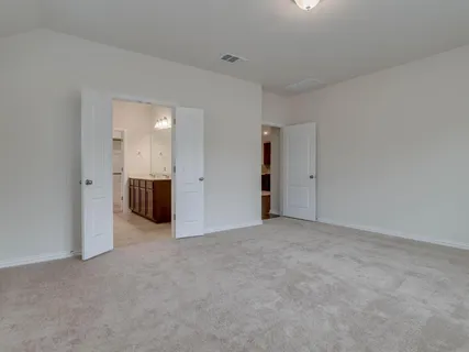 an empty room with kitchen and a yard