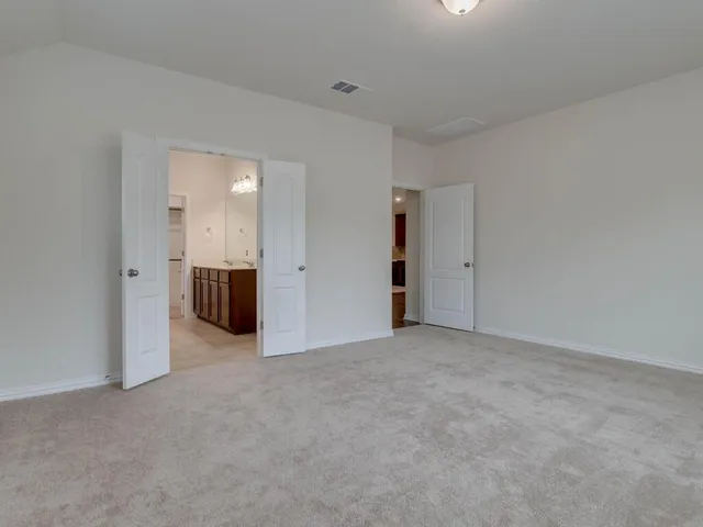 an empty room with kitchen and a yard