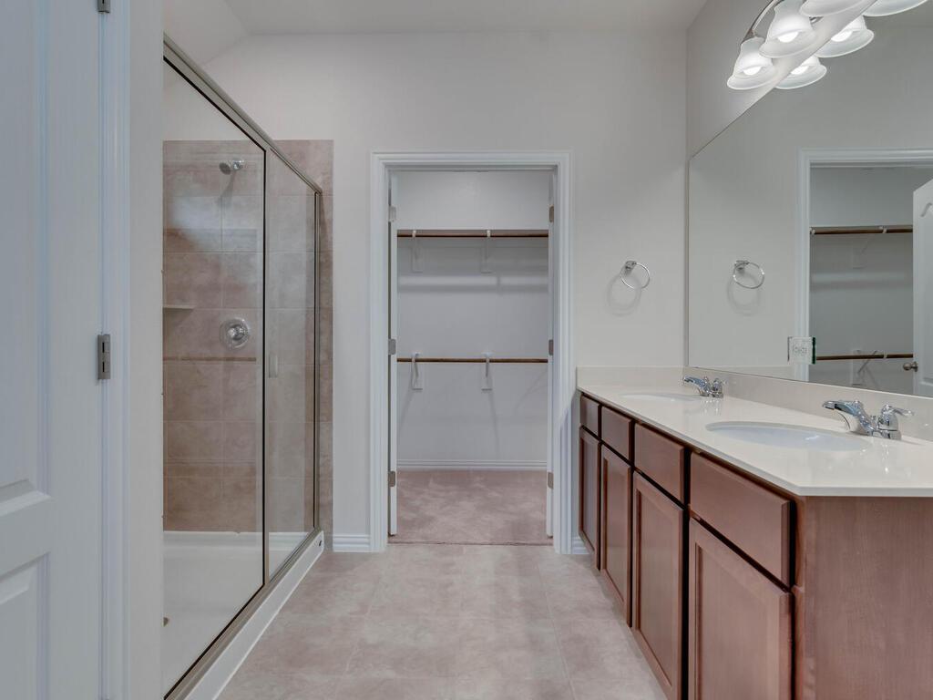 1104 Ridge Runner Drive Georgetown, TX 78628 - Photo 13 of 27 a bathroom with a shower sink and mirror