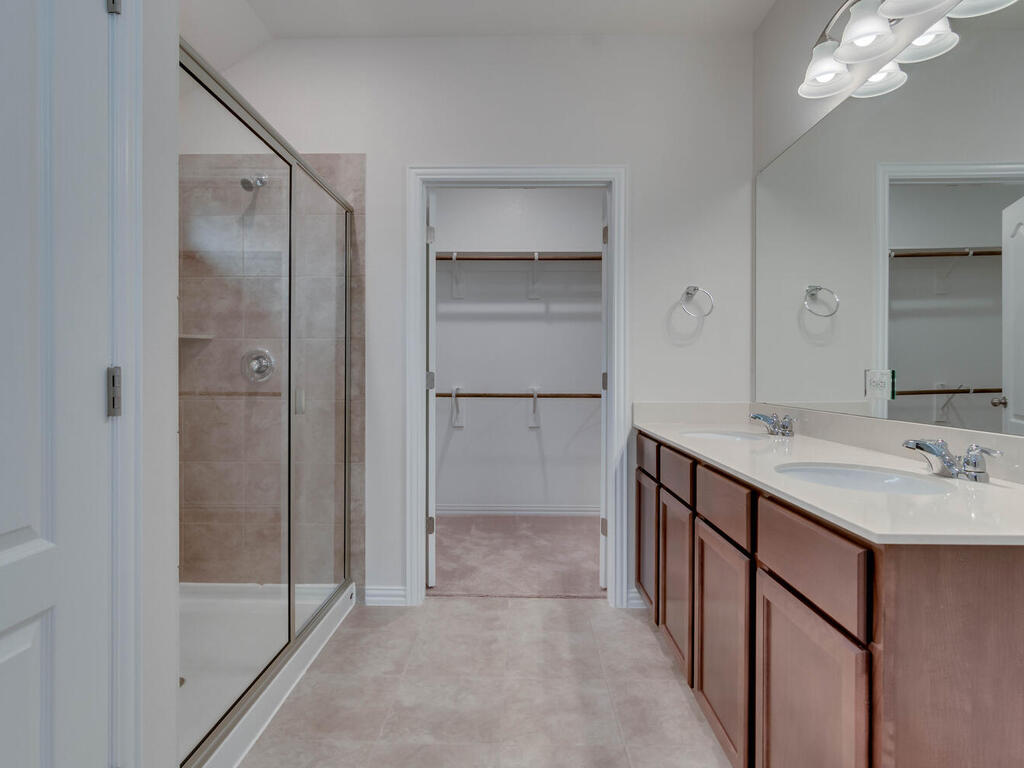 1104 Ridge Runner Drive Georgetown, TX 78628 - Photo 13 of 27 a bathroom with a shower sink and mirror