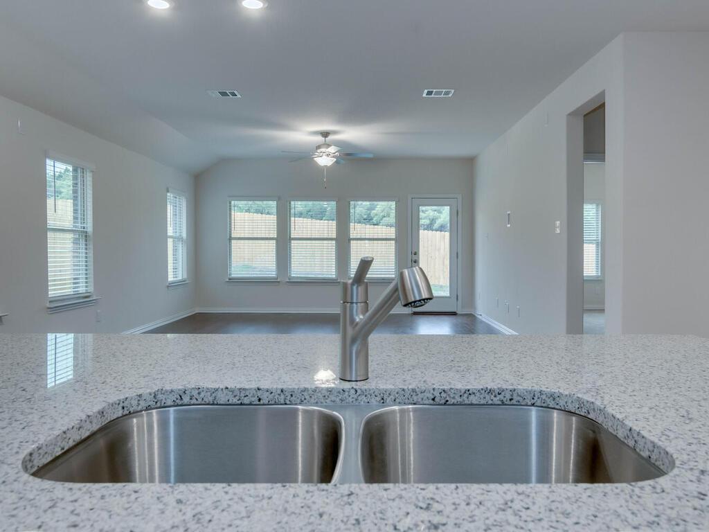 1104 Ridge Runner Drive Georgetown, TX 78628 - Photo 5 of 27 a kitchen with a sink granite counter tops and a window